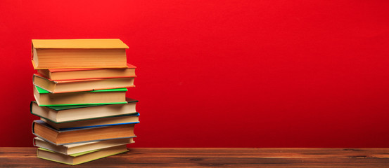  pile of old books, panorma, good copy space  on red background
