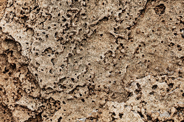 Different texture on the beach - water and sand, stones and pebbles, waves and splashes.