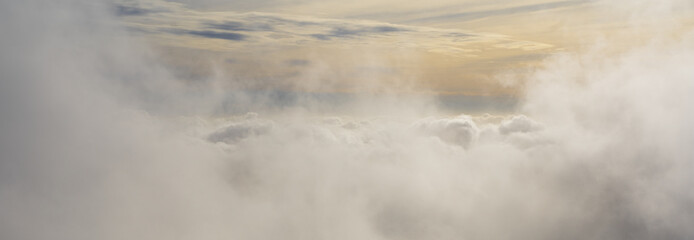 Landscape panoramic aerial above the clouds over the United Kingdom at sunrise