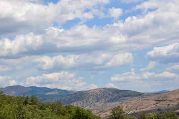 Naklejka na ściany i meble Beautiful clouds on a blue sky in the mountains. Crimean mountains