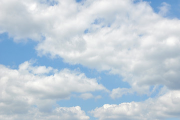 Naklejka na ściany i meble Beautiful white clouds on a blue sky. Background, texture