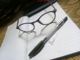 glasses and pen on a notebook