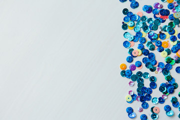 Colored and blue sequins on a white background