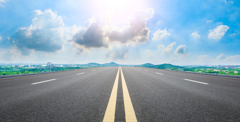 Wide asphalt highway and city suburb skyline on a sunny day in Shanghai,panoramic view.