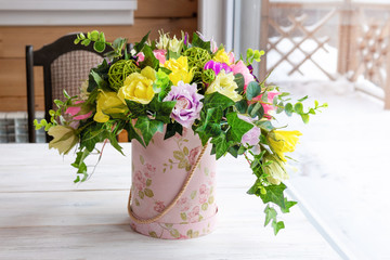 A bouquet of flowers made by a florist on a table made of wood.