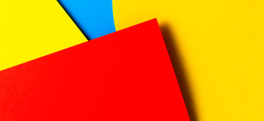 Abstract colored paper texture background. Minimal geometric shapes and lines in yellow, light blue, red colors