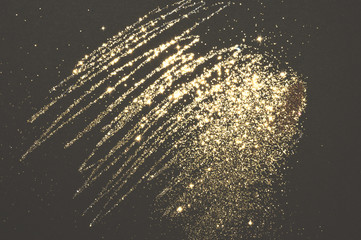 Gold glitter on black background for your design