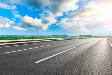 Fototapeta premium Empty asphalt highway and city suburb skyline on a sunny day in Shanghai.
