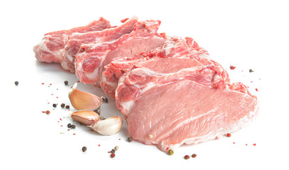 Raw pork meat with spices on white background
