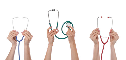 Many hands with stethoscopes on white background