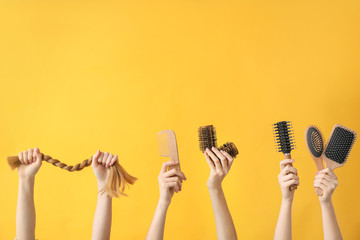Many hands with hairdresser's supplies on color background