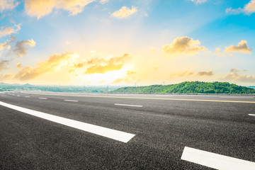 Empty asphalt road and green hill with beautiful sky sunset clouds.