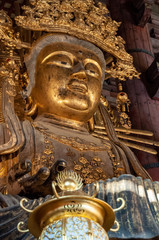 old golden Buddha statue in a Japanese temple