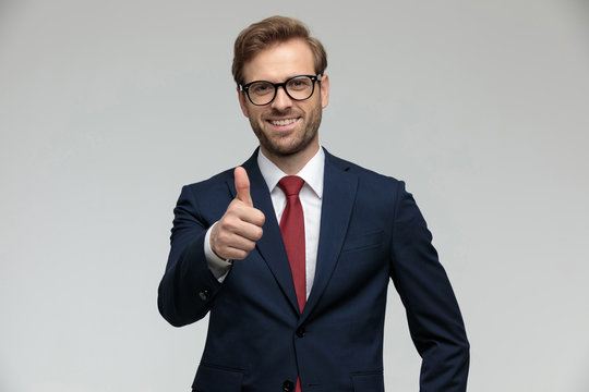 businessman standing and giving a thumbs up