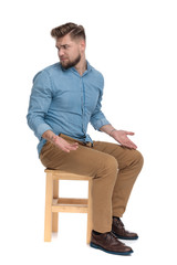 confused casual guy asking questions and looking to side
