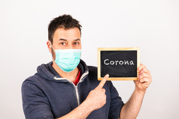 man with a mouthguard with blackboard isolated against white background and text corona