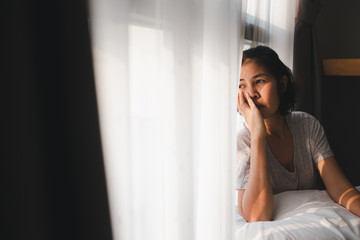 Fototapeta premium bored woman sit besides window
