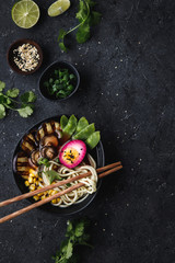 Noodle soup with vegetables and pickled egg. Top view with copy space.