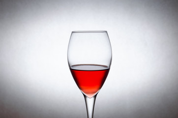 glass of red wine on a white background in motion. Freezing liquids in motion