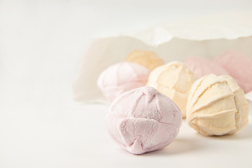 Multicolored air marshmallows in pastel shades, marshmallows in a light key.