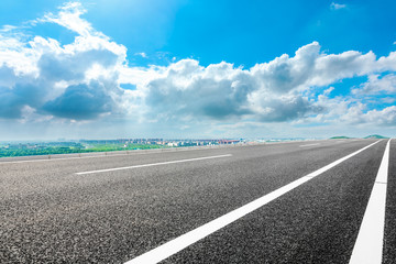 Fototapeta premium Empty asphalt highway and city suburb skyline on a sunny day in Shanghai.