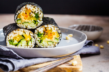 Vegan nori wraps with rice, hummus, vegetables and seedlings.