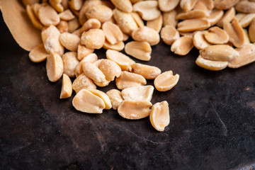 Salted peanuts on rustic background. Selective focus. Shallow depth of field.