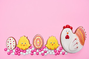 Easter gingerbread chickens and eggs over pink background