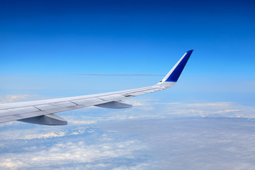 Airplane flying at high altitude and beautiful high-altitude clouds in spring