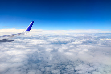 Airplane flying at high altitude and beautiful high-altitude clouds in spring