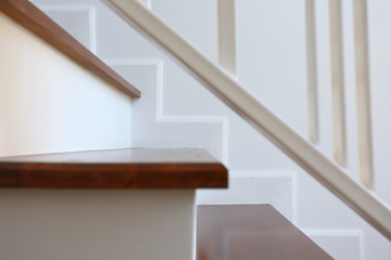 brown wooden stair and white wall in modern residential house