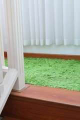 green carpet covering on laminate wooden stair