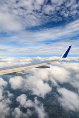 Airplane flying at high altitude and beautiful high-altitude clouds in spring