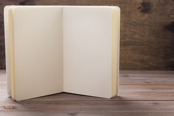 notepad or paper book at wooden table