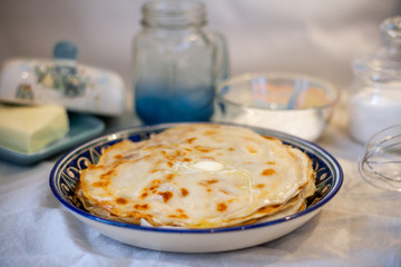Pancakes on a blue plate with melted butter