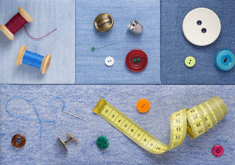 sewing tools and accessories on jeans background