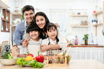 A happy family father, mother, son daughter is doing activities together in the room.