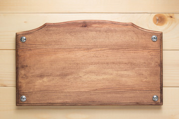 nameplate or wall sign at  wooden background