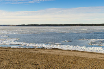 Spring landscape with melting ice on the river