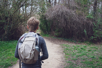 young hiker ,following path in woods.