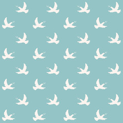 Dove with olive branch. A seamless vector pattern with doves flying in the blue sky.