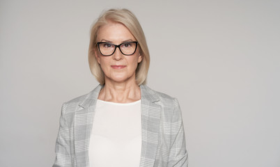 Senior blonde woman is wearing glasses isolated