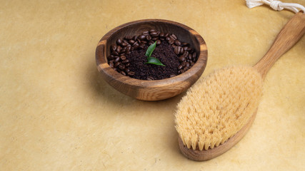 Natural organic anticellulite handmade coffee scrub in wooden bowl, massage brush, eco friendly background, skincare and weight loss concept, flat lay, copy space. Spa Set. Top View