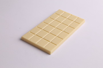 white chocolate tablet in color background