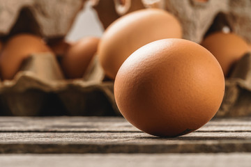 Close up of fresh chicken egg on nature wooden table