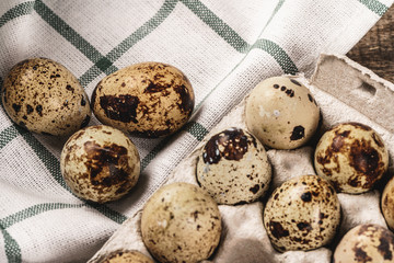 Quail eggs in cardboard box.
