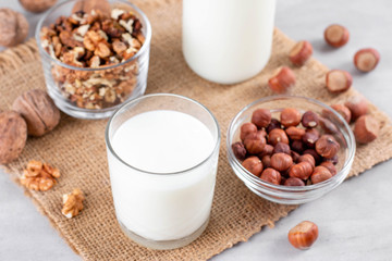 Vegan milk from nuts in glass jar with nuts
