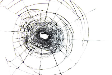 Hole and cracks on the glass from a shot from a weapon