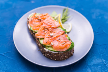 Sandwich with smoked salmon and cucumber. Concept for healthy nutrition.