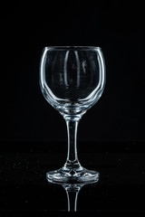Wine glass on black background, front view